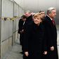 German Chancellor Angela Merkel leaving a tribute in a preserved segment of the Berlin Wall in 2014