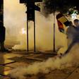 Supporters of Bolivia's presidential candidate Carlos Mesa are dispersed with tear gas by riot police during a protest in front of the Electoral Supreme Court