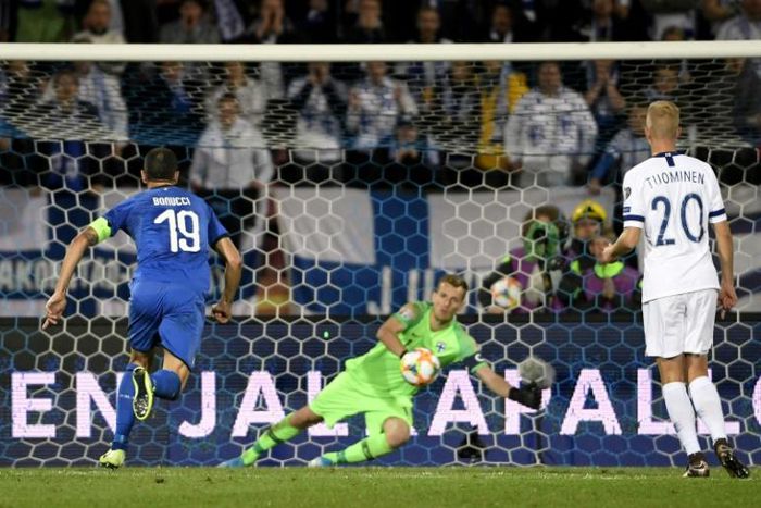 Finland's goalkeeper Lukas Hradecky fails to stop the penalty by Italy's Jorginho (not in picture)