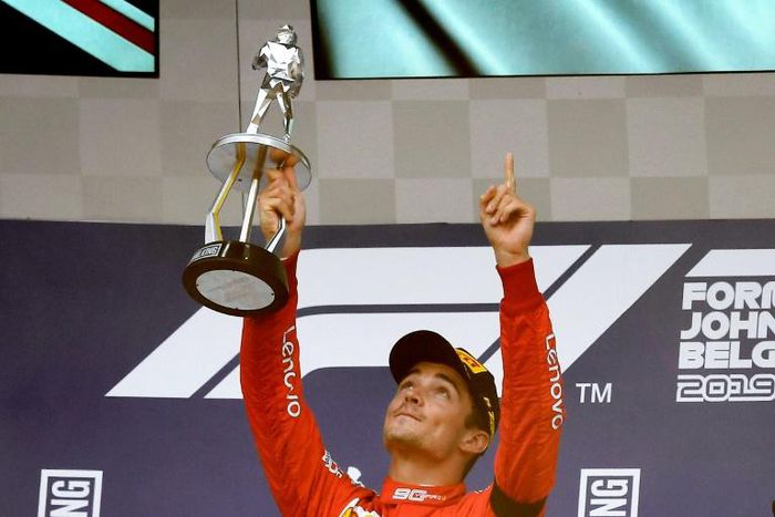 Ferrari's Charles Leclerc holds his trophy aloft after winning the Belgian Formula One Grand