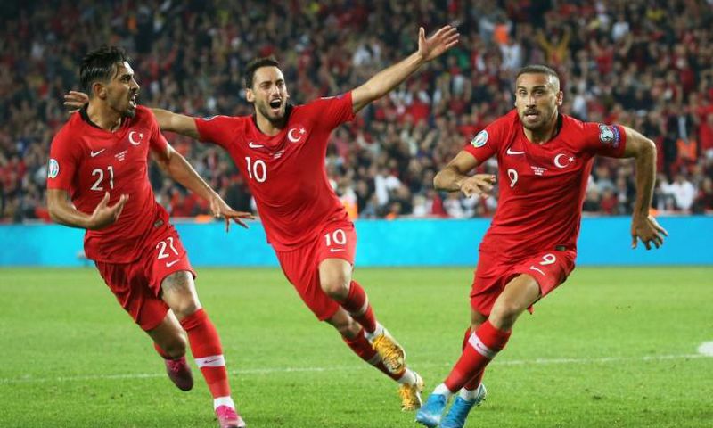 Turkey's forward Cenk Tosun (R) after scoring a late winner over Albania on Thursday