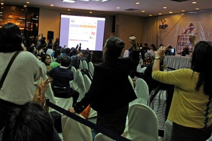 Rival election delegates in Bolivia shout slogans at each other in vote count headquarters