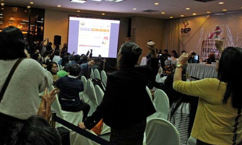 Rival election delegates in Bolivia shout slogans at each other in vote count headquarters