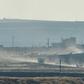 A convoy of Russian and Turkish military vehicles snakes its way along the Syrian side of border in the first joint patrol of a buffer zone set up under an agreement struck by Ankara and Moscow last week