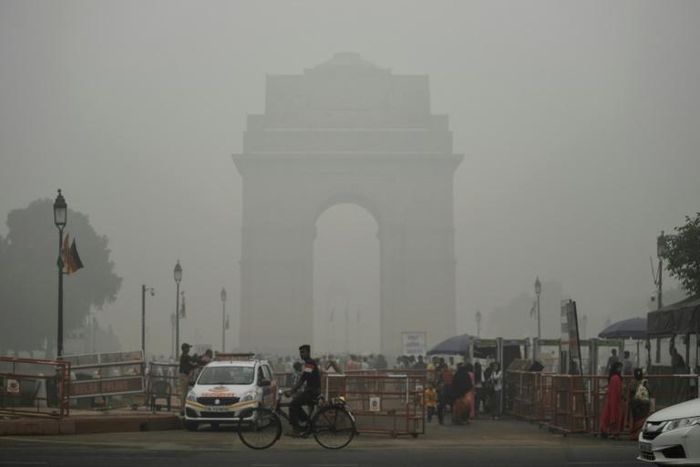 India Gate in New Delhi is pictured through a choking smog that has blanketed the capital