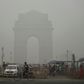 India Gate in New Delhi is pictured through a choking smog that has blanketed the capital