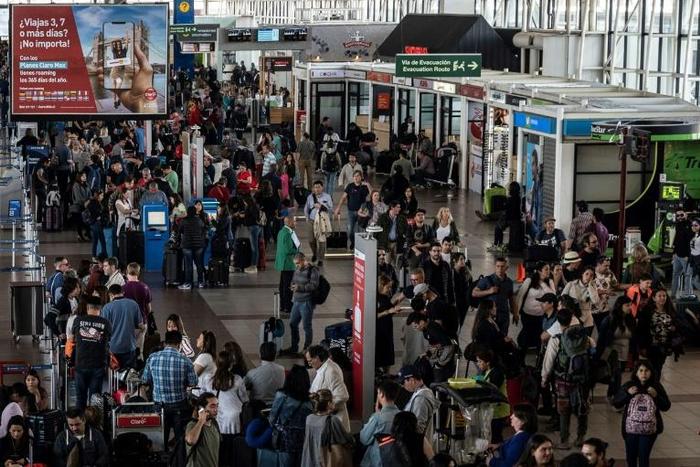 Thousands have been stranded at Santiago's international airport with flights cancelled and delayed because of unrest in the city