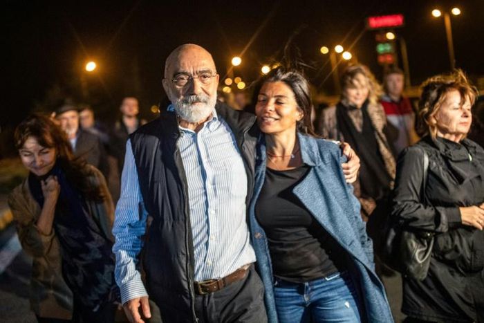 Turkish journalist and writer Ahmet Altan walks with his daughter Sanem Altan after being released from prison