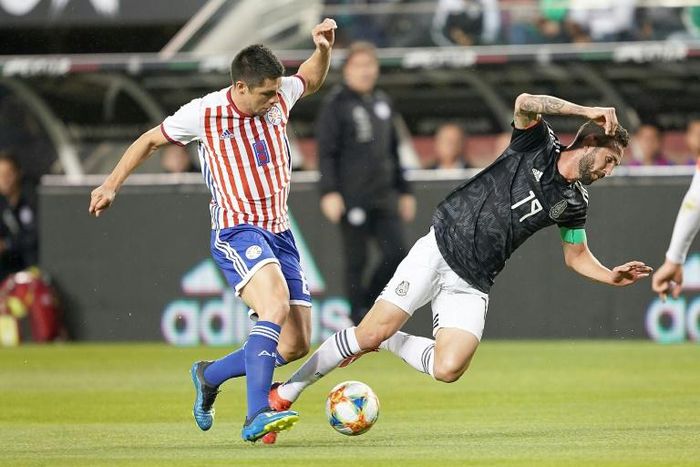 Miguel Layun #19 of Mexico National team battles for control of the ball with Paraguay's Rodrigo Rojas in Mexico's friendly victory over Paraguay in Santa Clara, California