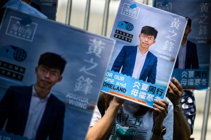 Posters of pro-democracy activist Joshua Wong are placed in front of the Central Government Complex as he announced in September his run for District Council elections in Hong Kong