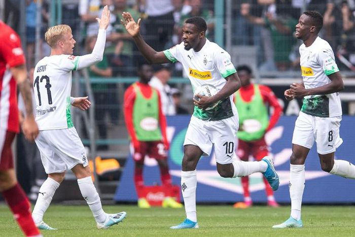 Borussia Moenchengladbach's French forward Marcus Thuram (C) celebrates with team mates after scoring both goals in their 2-1 come-back win against Fortuna Duesseldorf on Sunday in the Bundesliga.