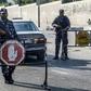 Security forces loyal to Palestinian Islamist movement Hamas man a checkpoint and stop vehicles in Khan Yunis in the southern Gaza Strip on Wednesday after two explosions overnight