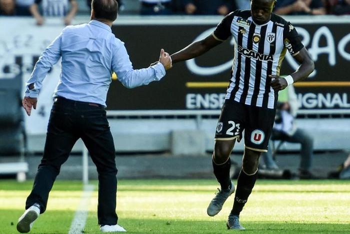 Chadian Casimir Ninga celebrates with coach Stephane Moulin after scoring for Angers against Saint-Etienne