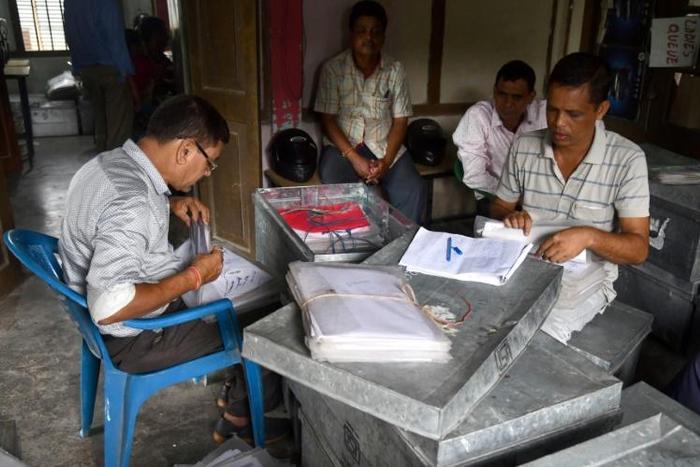 Workers from the National Register of Citizens check documents ahead of the release of the register's final draft in Guwahati, the capital of India Assam state