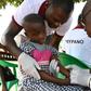 A health worker takes blood from a child in the Ivorian village of Paanenefla -- the sample will be tested for sleeping sickness