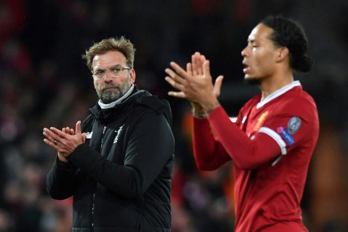 Liverpool manager Jurgen Klopp (left) and defender Virgil van Dijk (right) are embracing the pressure of a title race with Manchester City