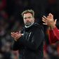 Liverpool manager Jurgen Klopp (left) and defender Virgil van Dijk (right) are embracing the pressure of a title race with Manchester City