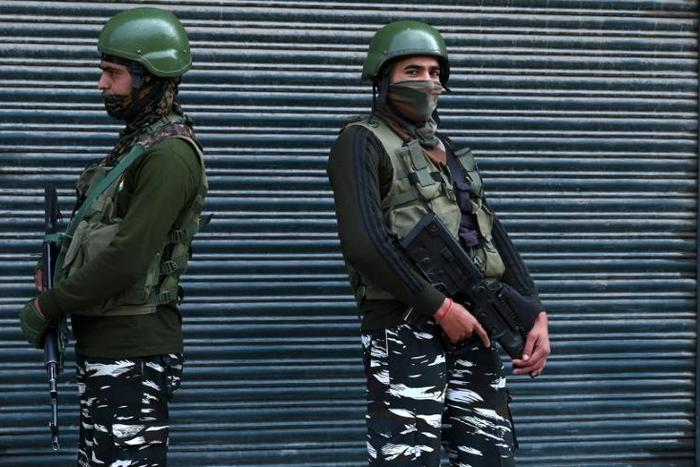 Indian paramilitary troopers stand guard during a lockdown in Srinagar