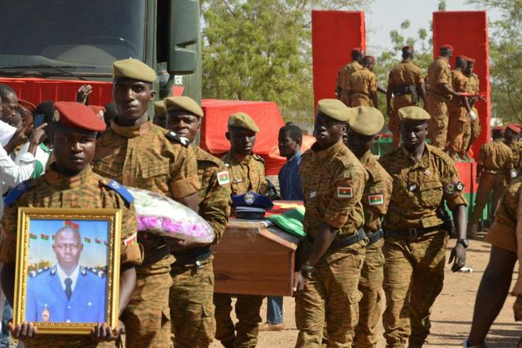 Burkinabe soldiers attend a funeral for eight soldiers killed in twin attacks in the Ouagadougou in March 2018