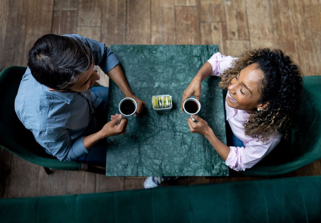 happy-couple-smiling-while-having-a-cup-of-coffee-