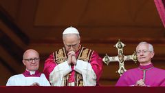 Pope Leo XIV, the former Cardinal Robert F. Prevost, prays as he stands on the central balcony of St. Peter’s Basilica at the Vatican after his election as pope May 8, 2025. The new pope was born in Chicago. (CNS photo/Lola Gomez)