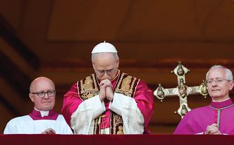 Pope Leo XIV, the former Cardinal Robert F. Prevost, prays as he stands on the central balcony of St. Peter’s Basilica at the Vatican after his election as pope May 8, 2025. The new pope was born in Chicago. (CNS photo/Lola Gomez)