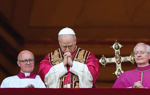 Pope Leo XIV, the former Cardinal Robert F. Prevost, prays as he stands on the central balcony of St. Peter’s Basilica at the Vatican after his election as pope May 8, 2025. The new pope was born in Chicago. (CNS photo/Lola Gomez)