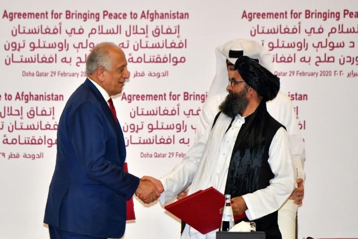 The agreement signed by US negotiator Zalmay Khalilzad (L) and the Taliban's Mullah Baradar was meant to set the conditions for a complete withdrawal of foreign forces from Afghanistan within just 14 months -- and end the longest war in US history