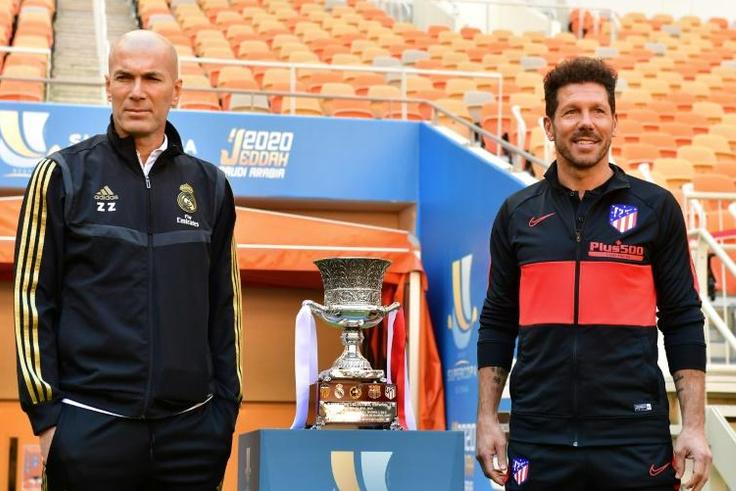 Zinedine Zidane and Diego Simeone pose next to the Spanish Super Cup trophy on the eve of the final in Jeddah