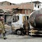 A fireman walks past the tanker truck that exploded in a Lima neighborhood on January 23, 2020, killing several people and igniting houses and cars