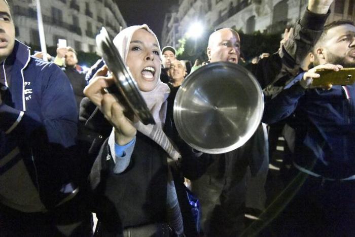 Algerians bang on pots and pans as they protest against the December 12 presidential election they say will cement in power a political elite rejected by the people