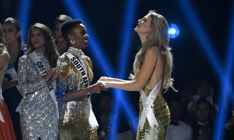 Miss South Africa Zozibini Tunzi (L) and Miss Puerto Rico Madison Anderson (R), the two finalists, wait to hear the winner's name on stage during the 2019 Miss Universe pageant at the Tyler Perry Studios in Atlanta, Georgia