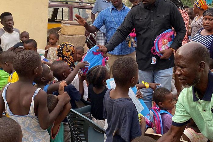 John Dumelo donates hundreds of school bags, exercise books to kids