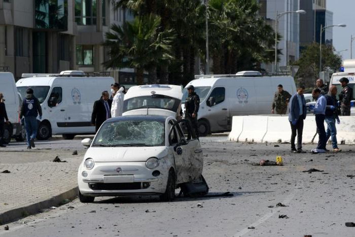 Police and forensic experts gather at the scene of an explosion near the US embassy in Tunis