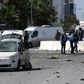 Police and forensic experts gather at the scene of an explosion near the US embassy in Tunis