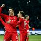 Bayern Munich's Poland forward Robert Lewandowski (C) celebrates scoring his 20th league goal this season after converting a penalty in Sunday's 4-0 away drubbing of Hertha Berlin.