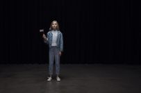 Small girl holding american flag and looking up in the light