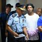 Brazilian football legend Ronaldinho (C) and his brother Roberto (R) arrive at Asuncion's Palace of Justice after being found using fake passports to enter the country
