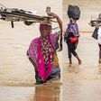 Photos of Ghanaian women dangerously crossing a stream with their babies are heart-stopping