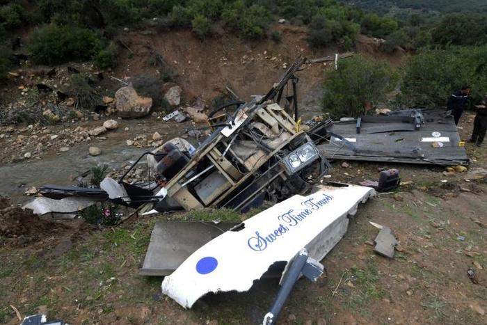 Tunisian security forces check the debris of a bus that plunged over a cliff into a ravine in northern Tunisia