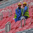 Workers take a break at the Al-Bayt stadium under construction for the 2022 Qatar World Cup and one of several where the workforce has been hit by COVID-19