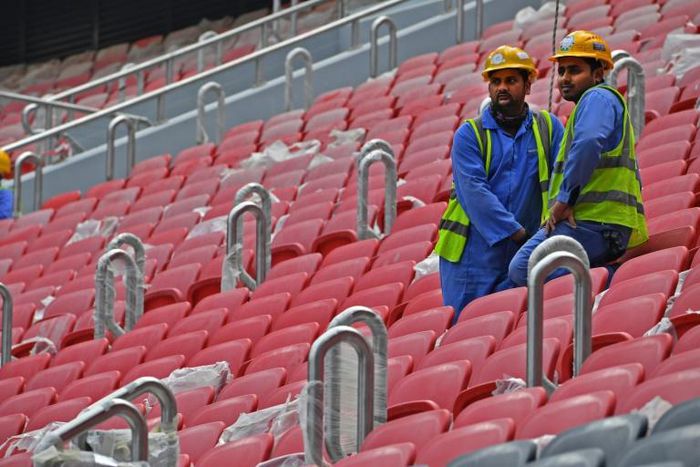 Workers take a break at the Al-Bayt stadium under construction for the 2022 Qatar World Cup and one of several where the workforce has been hit by COVID-19