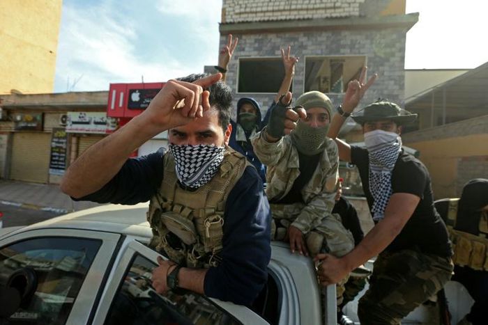 Fighters loyal to Libyan's UN-recognised Government of National Accord celebrate after the capture of the coastal city of Sabratha from forces of military strongman Khalifa Haftar