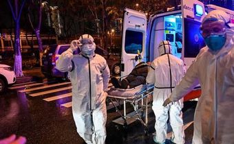 Medics handle an infected patient. Ambassador Sarah Serem cancels leave to return to her post in  China amid Coronavirus crisis