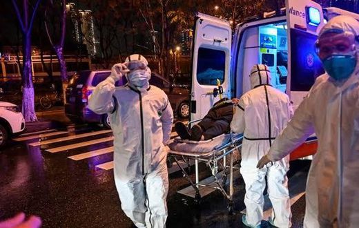 Medics handle an infected patient. Ambassador Sarah Serem cancels leave to return to her post in  China amid Coronavirus crisis