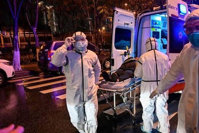 Medics handle an infected patient. Ambassador Sarah Serem cancels leave to return to her post in  China amid Coronavirus crisis