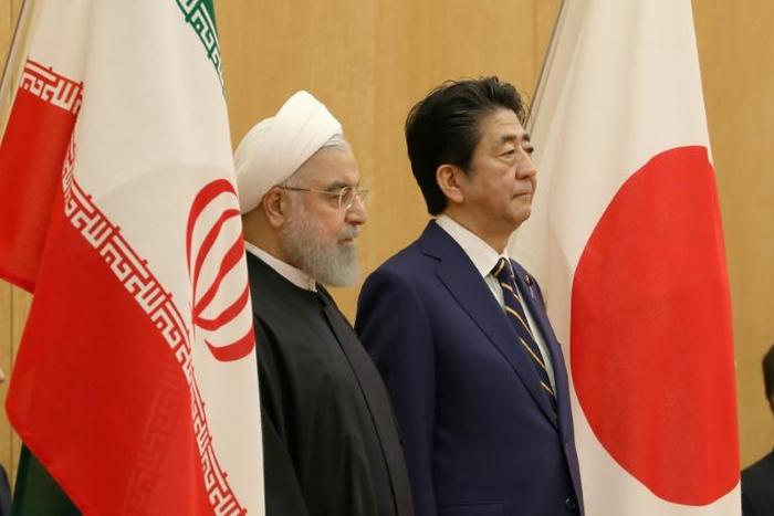 Japanese Prime Minister Shinzo Abe (R) with Iranian President Hassan Rouhani in Tokyo in December 2019. Tokyo and Tehran have longstanding ties and Abe is hoping to help ease regional tensions with his trip to Saudi Arabia, Oman and the UAE