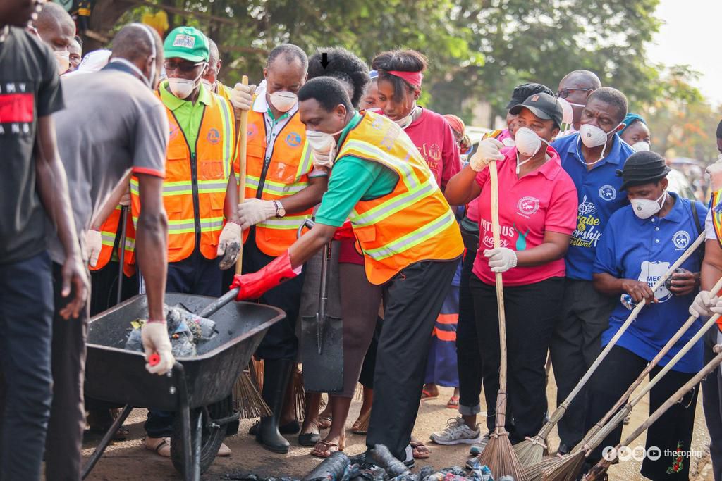 Apostle Eric Nyamekye (arrowed) cleaning the Madina Market