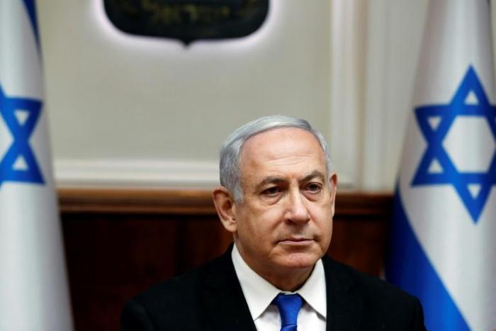 Israeli Prime Minister Benjamin Netanyahu has agreed to step down from all of his ministerial posts by the end of the year, but campaigners say he should give up the premiership too following his indictment on corruption charges last month