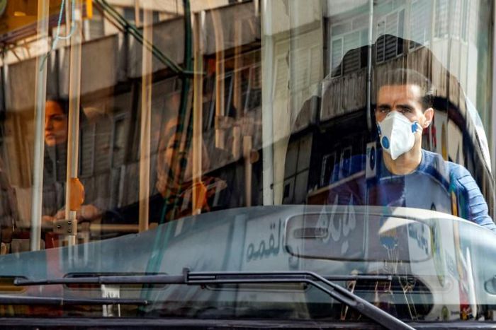 A Tehran bus driver wearing a protective mask as a precaution against coronavirus